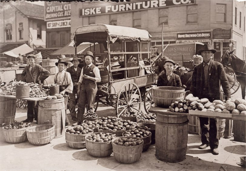 Fruit Market: 1908 Indianapolis Market. August 1908. Wit., E. N. Clopper. People shopped at open-air markets like this for fresh produce before the advent of the supermarket, which was basically a self-service farmers market, butcher shop and dry goods store all under one roof. View full size.