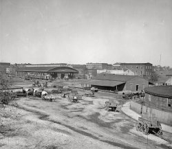 1864. Atlanta, Georgia. "Atlanta railroad depot and yard; Trout House and Masonic Hall in background." From a series of photographs, "War in the West," made by George N. Barnard. Wet-plate glass negative. View full size.

"Sherman in Atlanta, September-November 1864. After three and a half months of incessant maneuvering and much hard fighting, General Sherman forced Hood to abandon the munitions center of the Confederacy. Sherman remained there, resting his war-worn men and accumulating supplies, for nearly two and a half months. During the occupation, George N. Barnard, official photographer of the Chief Engineer's Office, made the best documentary record of the war in the West; but much of what he photographed was destroyed in the fire that spread from the military facilities blown up at Sherman's departure on November 15."