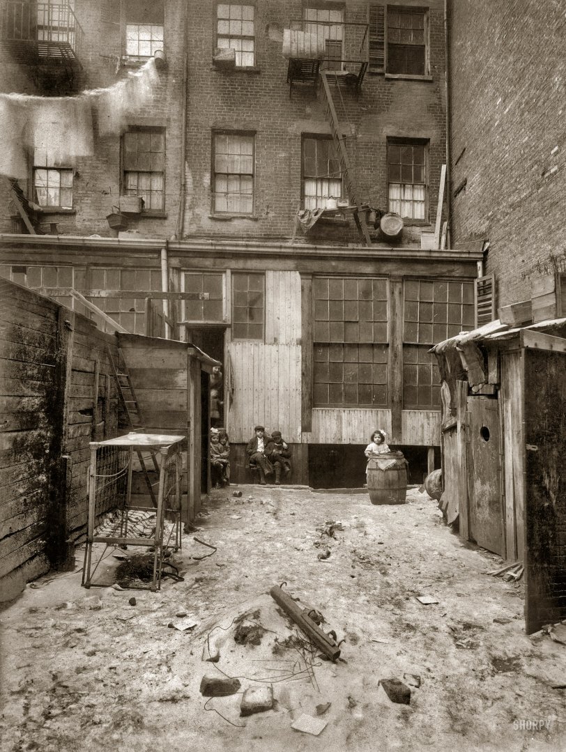 Thompson Street: 1912 February 1912. "Rear view of tenement, 134½ Thompson Street, New York City. Makers of artificial flowers live and work here." Photograph and caption by Lewis Wickes Hine. View full size.