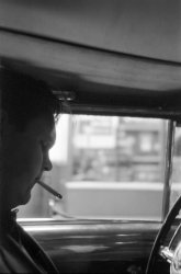 I never did get the full skinny on how it all went down that day. All I know is that it was my brother and his pal, this guy. A couple of ex-Catholic high school boys; you know the type - four years in, walk out with a fancy piece of paper, the whole nine yards. Then two years later they're back in town, cruising the mean streets, past all the usual joints - Montgomery Ward, J.C. Penney, F.W. Woolworth, Thom McAn, The Cottage Bookshop. That's right: San Rafael, California.

When it happened, it happened fast. First his pal pulls up and parks, lights himself a cig, happy as a clam, not a worry in the world. Then my brother hauls off and shoots him with his Lordox, a German 35mm job loaded with Kodak Tri-X. For years afterwards my brother keeps this pic pasted in a book or something. What a crazy guy. View full size.