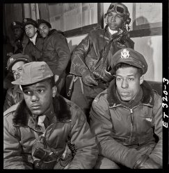 332nd Fighter Group airmen at a briefing in Ramitelli, Italy. March 1945. Foreground: Emile G. Clifton of San Francisco and Richard S. "Rip" Harder of Brooklyn. Photo by Toni Frissell. View full size.