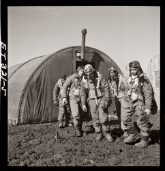 Tuskegee airmen exiting the parachute room at Ramitelli, Italy. March 1945. From left: Richard S. "Rip" Harder, Brooklyn, Class 44-B; unidentified airman; Thurston L. Gaines Jr., Freeport, N.Y., Class 44-G; Newman C. Golden, Cincinnati, Class 44-G; Wendell M. Lucas, Fairmont Heights, Maryland, Class 44-E. Photo by Toni Frissell. View full size.