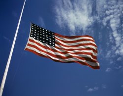 "The floating folds of the Star Spangled Banner symbolize the American way of life to soldiers in training for the battles that will bring freedom to an unhappy, wartorn world." Fort Knox, Kentucky, June 1942. View full size. 4x5 Kodachrome transparency by Alfred Palmer. 