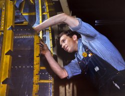 July 1942. Fairfax bomber plant, Kansas City. "A wing brace for a B-25 bomber being prepared for the assembly line at North American Aviation. With plenty of speed, a 1,700-mile cruising range and a ceiling of 25,000 feet, the B-25 has performed as a medium bomber and as an escort plane. General Doolittle has called the ship the best military plane in existence." 4x5 Kodachrome transparency by Alfred Palmer, Office of War Information. View full size.
