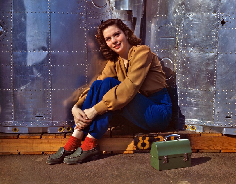 Rosie Takes a Break: 1942 October 1942. "Noontime rest for an assembly worker at the Long Beach, Calif., plant of Douglas Aircraft Company. Nacelle parts for a heavy bomber form the background." View full size. 4x5 Kodachrome transparency by Alfred Palmer.