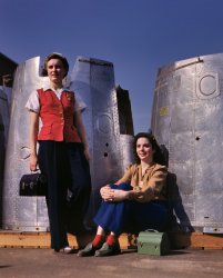 October 1942. "Two assembly line workers at the Long Beach, California, plant of Douglas Aircraft Company enjoy a well-earned lunch period. Nacelle parts of a heavy bomber form the background." 4x5 Kodachrome transparency by Alfred Palmer for the Office of War Information. View full size.