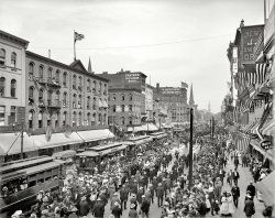 Buffalo, New York, 1900. "Labor Day parade, Main Street." The Clairvoyant Bird Woman observes from her perch. Detroit Publishing Company. View full size.