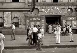 October 1935. Matinee at the Casino Cinema in Amite City, Louisiana. Among the current offerings: Laurel and Hardy in "Tit for Tat." View full size. 35mm nitrate negative by Ben Shahn for the Farm Security Administration.