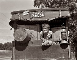 June 1939. Migrant child in family car east of Fort Gibson. Muskogee County, Oklahoma. View full size. 35mm nitrate negative by Russell Lee.