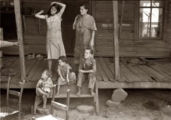 Summer 1936. Children of sharecropper Frank Tengle at their Hale County, Alabama, cabin. View full size. 35mm nitrate negative by Walker Evans.