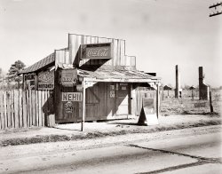 December 1935. "Coca-Cola shack in Alabama." Photograph by Walker Evans. Back in the 1930s  just about any building or barn was like a Web site -- you could rent out the blank spaces for banner ads (in this case for the circus in Montgomery). View full size.