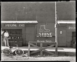 "Shoeshine stand, Southeastern U.S., 1936. (Title and date from Walker Evans, 1973. No caption for this image in FSA/OWI shelflist.)" Who will be the first Shorpyite to clear up a longstanding curatorial mystery and figure out where this is? Large-format safety negative by Walker Evans for the FSA. View full size.