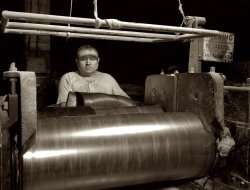 December 1941. Goodrich plant at Akron, Ohio. "Rubber stock for track treads of scout cars and other Army halftrack vehicles is milled in one Ohio tire plant. All rubber firmly 'welded' to the steel parts is formed into one tough durable piece." View full size. 4x5 negative by Alfred Palmer for the Office of War Information.