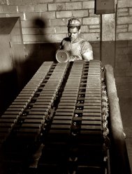 December 1941. B.F. Goodrich factory at Akron. "Treads for Army halftracks, fresh from the curing press of a large Ohio tire plant. Grooves are buffed on the ends of the track section." View full size. 4x5 nitrate negative by Alfred Palmer.