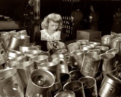 February 1942. "Aluminum casting. A woman's place in this large Midwest aluminum factory is on the inspection line. She's giving a final checkup on these aluminum pistons which are destined for use by America's armed forces. Destination of the finished aluminum products is kept secret. They'll probably end up as jeep or airplane engine parts. Aluminum Industries Inc., Cincinnati." Medium format nitrate negative by Alfred Palmer for the OWI. View full size.