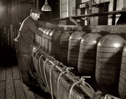February 1942. Akron, Ohio. Another esoteric industrial process involving scary-looking thingamabobs essential to the war effort. Executive summary: Performing a painstakingly choreographed ballet of complicated tasks at precisely timed intervals, Joe Warworker here is doing his part to Speed Victory! View full size. 4x5 nitrate negative by Alfred Palmer for the Office of War Information.