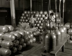 February 1942. Akron, Ohio. Firestone Rubber. "Conversion. Beverage containers to aviation oxygen cylinders. After shatterproof oxygen cylinders for high altitude flying have passed all tests in the metal division of a large Eastern rubber factory, hot air is blown through the cylinders to remove all trace of moisture. The cylinders are then sealed and stacked for painting." 4x5 nitrate negative by Alfred Palmer for the Office of War Information. View full size.