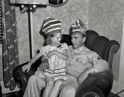 August 1942. "George Woolslayer celebrated the visit of the soldier and sailor with a party at his home. Friends, relatives and fellow workers made up the list of guests. No ordinary party, this one will be remembered by the Woolslayers for years to come. Festivities started at 8 p.m. and lasted well into the next morning. Proudly seated on Sergeant French L. Vineyard's knee is Woolslayer's 8-year-old daughter, Georgia Ann, who stayed up long past her bedtime to take part in the fun. Allegheny-Ludlum Steel, Pittsburgh, Pennsylvania." View full size. Medium format negative by Alfred Palmer for the Office of War Information.