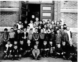 This despondent looking crew are the drawn from the various Scandanavian, German, and Irish families settled in or near Wadena, Minnesota during the late 1800s. Wadena, located in the west-central part of the state, was (and is) a pretty small town, so some of these kids probably had an epic daily commute, by foot, from farm to school house.  Identities are unknown except for Bernard Francis Burch (1889-1985), third from left in the first standing row. View full size.