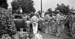 When my Aunt Rose passed away I came into possession of her photos and negatives. There were very few photos but a pile of big negatives, many of which I half suspect were never printed, or perhaps were printed once and the photos lost a long time ago. She wasn't in the habit of documenting her snapshots, so each one is to me a mystery.

None is more mysterious than this. I don't know who the speaker is, or the occasion, but the location could be either northern Philadelphia or the Quakertown Pa. vicinity. One small hint might be the "Pa SRG" shoulder emblems. the time period is probably the late 1930s or early War years. View full size.