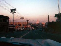 This is the city: Los Angeles, California. It was a warm August evening in city; we were working the tourist detail and wound up heading toward City Hall. The car is a '59 Rambler, the driver my brother-in-law Frank. My name's tterrace; I'm a kid.

I'd flown in on a turbo-prop job from San Francisco. It was my first flight and my first trip anywhere by myself. I'd just turned 15. I would have gotten there sooner, but a couple weeks earlier my father had gotten me almost all the way to SFO when I found I didn't have my plane ticket, so we had to turn back. Nobody was happy about that.

My Kodak Brownie Starmite was loaded with Ektachrome when I snapped this shot on some street somewhere or other; some local might be able to fill in the blanks on that one. Later, we hit the usual places: Chinatown, Olvera Street, Union Station. Disneyland would be for another day. With any luck, I wouldn't die of excitement before then. View full size.