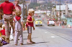 Larkspur, California July 4, 1974. The beginning of the parade is heading this way on Magnolia Avenue, just passing the crowd at the right gathered in front of the Silver Peso bar, still a major draw downtown. The fire trucks are from Larkspur and Corte Madera, who jointly host the Twin Cities Parade and other festivities each year. If there's any lingering doubt about this being the 1970s, I offer in evidence: that guy's pants. I shot this 35mm Kodacolor II negative with a 135mm telephoto lens. View full size.
