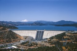 Three of them, in fact: the Mount, the Lake, the Dam, and a perfect day for Kodachrome. We were on the next-to-last-last leg our 1965 summer vacation trip to Mounts Lassen and Shasta, about to head to the coast and the giant redwoods to be driven amongst there and thence homeward. We being my mother, father, older brother and our 1956 Rambler station wagon, performing its last family trip transport duty. Next year it would be a 1966 Rambler wagon.  View full size.