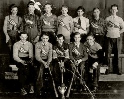 My Dad Lorne (bottom left) and my Uncle Ray (top right) with the rest of the baseball team from Rossland High School in Rossland BC Canada. I don't know what the trophy was for, but I do love the pinned on pennants they are all wearing. This would be about 1935. 
