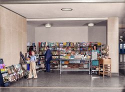 This is my colorized version of this Shorpy photo.   I tried to research every magazine cover and was able to find around 85% of them.   I also was able to find most of the cigar boxes and candy. Colorized version of View full size.
