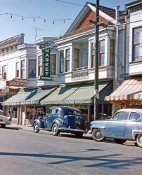 Back we go to my home town of Larkspur, California for another view of the Rainbow Market, where my father worked for several years in the mid-1950s. The linked photos and their comments give plenty of background, so here I'll just mention a couple childhood memories this one dredges up (I was 9 at the time my brother took this Anscochrome slide). The hulking 1930s black sedan belonged to my mother's friend Mrs. Skala, who a year later bought a 1956 Plymouth from Hil Probert, whose DeSoto-Plymouth dealership was across the street from our house a couple blocks away. My mother was incensed that Probert allegedly talked the 60ish lady into a model with the push-button automatic transmission. "Imagine the poor woman trying to learn how to use something like that at her age. The idea." Well, that's a paraphrase, but I never did hear if Mrs. Skala had any problems. Mr. Gilardi, the butcher who's billed on the market's window, had a portion of one finger missing from some slicing or chopping mishap, so naturally that's what I always stared at while my mother talked pot roast or ground chuck with him. Or maybe that was Charlie Young, the butcher at Fred Schefer's Food Center next door to the right. We switched our trade to the Food Center after my father left the Epidendios' employ. Final period note: on the telephone pole, a poster for the United Crusade, a charity forerunner of the United Way. That and the March of Dimes were annual Larkspur events I recall, although I was probably more interested in fantasizing about the dimes being potential fodder for my coin collection. View full size.