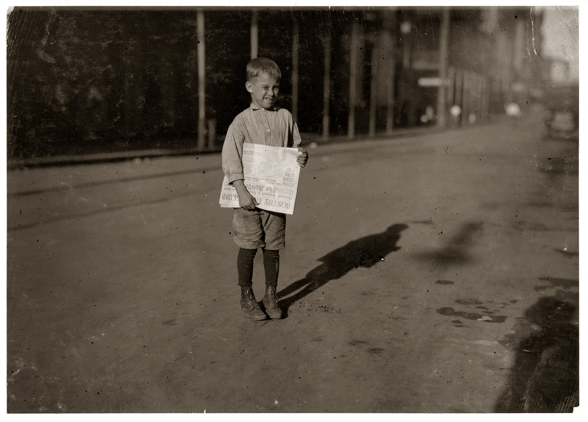 October 1914. Mobile, Alabama. "Young newsboy who begins work at daybreak." Photograph by Lewis Wickes Hine.