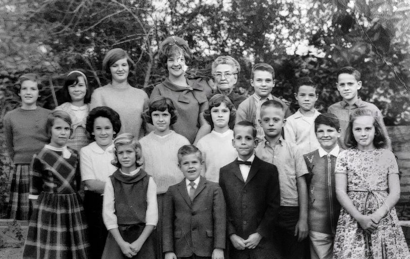 Class Notes: 1964 Cucamonga, California, circa 1964. My piano teacher Mrs. Stewart, who seemed impossibly old when I was 8 years old 61 years ago, STILL seems impossibly old. Her equally old husband took a photo of her students every year with his big 1920s box camera; this is the only one of three that I still possess. I am third from the right in the front row, with the crew cut. To my right is Bruce D., with the bow tie; next to him is a kid I only know as Russell. Next to him is Patty L., and all of us boys liked her. Mrs. Stewart had quarterly recitals, and she would tape our performances and play us back our mistakes the next lesson. View full size.