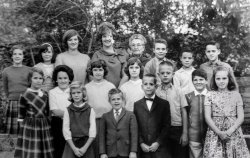 Cucamonga, California, circa 1964. My piano teacher Mrs. Stewart, who seemed impossibly old when I was 8 years old 61 years ago, STILL seems impossibly old.  Her equally old husband took a photo of her students every year with his big 1920s box camera; this is the only one of three that I still possess. I am third from the right in the front row, with the crew cut.  To my right is Bruce D., with the bow tie; next to him is a kid I only know as Russell. Next to him is Patty L., and all of us boys liked her. Mrs. Stewart had quarterly recitals, and she would tape our performances and play us back our mistakes the next lesson. View full size.