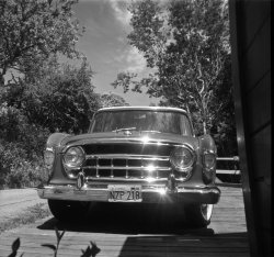 Glistening from a wash, wax and chrome polish job by sixteen-year-old me, our 1956 Rambler station wagon basks in the sun on the ramp of our garage on Walnut Avenue in Larkspur, California on a summer day in 1962. I'm sure I was paid something whenever I did this, but I actually enjoyed it; in fact, I always volunteered. I recorded my effort this time by clicking off three shots with my Kodak Brownie Starmite, using Perutz black-and-white 127 roll film. Fun auto fact: since we bought it from a Hudson dealer, our Rambler was Hudson-badged; it and Nash badges were discontinued after the 1957 model run. View full size.