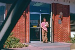 August, 1976. Another forgotten photo from that forgotten road trip to Southern California I took with my friend who also forgot about this Kodachrome slide he took but didn't forget about the road trip. Go that? Anyway, I figure this is as we returned home to Marin County and we've stopped at the Corte Madera post office to pick up my mail from my p.o. box. I had the box there because I worked there at the post office. Corte Madera is right next door to Idyllic Larkspur™, where I lived. The plaque to the right of the door marks the dedication of the building, at which I was in attendance: "This building dedicated to public service - 1969 - Richard M. Nixon President of the United States - Winton M. Blount Postmaster General." Neither gentleman was able to attend. Blount, incidentally, was the last Postmaster General to sit in the presidential cabinet. View full size. 