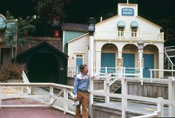 Rainbow Ridge is a community of scale model and forced-perspective buildings in Frontierland in Disneyland. It traces back to the earliest days of the park, decorating the loading area for various incarnations of a miniature train ride. Some of it remains in the current version at the start of the Big Thunder Mountain Railroad attraction. I was always gaga over models, so it was one of my favorite places in Disneyland. Little did I know there was a photo of me there; in fact, my friend who took this Kodachrome slide didn't know about it either, until we came upon a box of forgotten slides at his place. I think it's around closing time, thus the absence of crowds. View full size.