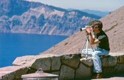 In this image that I didn't know existed until a few days ago, I'm aiming my Nizo Super-8 movie camera across the waters of Oregon's Crater Lake. I'm on a trip with my brother and my friend who took this Kodachrome slide. It's among scores we discovered in a forgotten box in a spare room at his place. View full size.