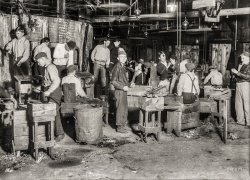 November 1909. "Night scene in Cumberland Glass Works, Bridgeton, N.J." Mak&shy;ing bottles one at a time. Glass negative by Lewis Wickes Hine. View full size.
