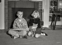 Columbus, Georgia, circa 1955, and the youngsters last seen here. The Buick is out of the picture, replaced by a battleship and a cat; clothes and hair have been upgraded. 4x5 negative from the Shorpy News Photo Archive. View full size.