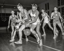 From around 1960 in Columbus, Georgia, comes this News Archive snap of Baker Lion No. 13 liberating the basketball from an opposing player who does Not. Look. Happy. But that's the way the ball bounces in high school hoops. 4x5 inch acetate negative. View full size.