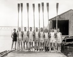 Summer 1914. "Penn 2nd varsity crew team in Poughkeepsie." Rowers at the boathouse. Bain News Service glass negative. View full size.