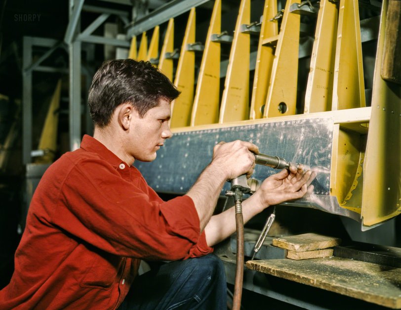 Roger the Riveter: 1942 October 1942. "Riveter at work at the Douglas Aircraft plant in Long Beach, California." Kodachrome transparency by Alfred Palmer. View full size.