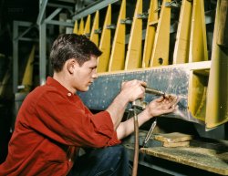 October 1942. "Riveter at work at the Douglas Aircraft plant in Long Beach, California." Kodachrome transparency by Alfred Palmer. View full size.