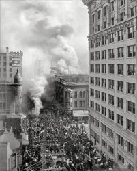 Nov. 15, 1908. "Los Angeles Pacific Railroad fire, Fourth Street between Hill and Broadway." 8x10 glass negative, photographer unknown. View full size.


Los Angeles Express, Nov. 16, 1908:

FIRE DESTROYS L.A.P. BUILDING

&nbsp; &nbsp; &nbsp; &nbsp; Flames broke out in the basement of the Los Angeles Pacific building at 314 W. Fourth St., adjoining the Broadway Department Store, at 2 o’clock yesterday afternoon and threatened serious loss.

&nbsp; &nbsp; &nbsp; &nbsp; The fire is believed to have had its origin in the rear of the basement, under the Sunset Bakery, at 320 W. 4th Street.

&nbsp; &nbsp; &nbsp; &nbsp; Fourth Street from Broadway to Hill was speedily roped off to keep the crowds back, and Broadway became a mass of humanity within a few minutes. Great volumes of smoke could be seen rolling up over the Broadway Department Store, creating the impression that it was that great store which was burning.

&nbsp; &nbsp; &nbsp; &nbsp; So quickly did the flames spread in the lower portions of the Los Angeles Pacific Building that the clerks and stenographers of the railway company in the offices on the second floor could not reach safety by the stairway or elevator. Fifteen girls and women were taken from the windows of the second floor with ladders.

&nbsp; &nbsp; &nbsp; &nbsp; The clouds of smoke that rolled from the building did not begin to compare in size with the cloud of spectators which sought to reach the scene of the fire.
