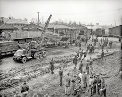 Jan. 26, 1937. "Fort Belvoir troops proceed to flood area. Company B of the 5th Regiment of Engineers, stationed at this Virginia post a short distance from the Capitol, mobilized complete campaign equipment today and prepared to entrain immediately for the devastated flood area near Louisville, Kentucky. One of the boats to be used is shown being put aboard a railcar." View full size.