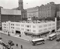 Washington, D.C., circa 1940. "Star Parking Plaza, 10th and E Streets N.W." This Motor Age landmark with Art Deco touches was erected by the publisher of the Washington Evening Star. The clock tower of the Old Post Office, soon to be the Trump Hotel D.C., rises at rear. 4x5 inch glass negative. View full size.