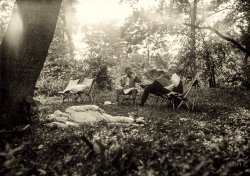 &nbsp; &nbsp; &nbsp; &nbsp; During the week of July 21-27, 1921, Thomas Edison, Henry Ford and Harvey Firestone camped at a site about six miles east of Hancock in Washington County, Maryland. During the weekend, President Warren G. Harding joined the “vagabonds” — the name the wealthy industrialists gave themselves when they camped together. The 200-acre farm where they made camp was located about one mile north of the National Turnpike along Licking Creek. Today, the campsite lies inside Camp Harding County Park. A plaque memorializes the gathering of these famous campers.
-- Maryland Dept. of Natural Resources
July 1921. "Warren Harding at Firestone camp." The president with industrialist Harvey Firestone and the inventor Thomas Edison (napping). Harris & Ewing Collection glass negative. View full size.