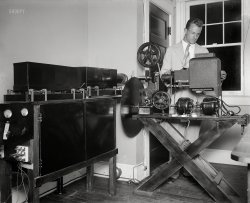 &nbsp; &nbsp; &nbsp; &nbsp; UPDATE: "Pioneer television inventor (Dr. C. Francis Jenkins, not pictured) opens new radio movie broadcasting station. Laboratory assistant Paul Thomsen examining machine made to broadcast motion pictures by radio." More photos here.
Washington, D.C. July or August 1929. "NO CAPTION" is all it says on this Harris & Ewing glass negative with an audiovisual vibe. Who can help us fill in the blanks?  View full size.