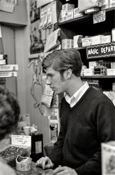 "Store clerk, Little Jack Horner joke shop, Boston, 1967." Please do not handle the Jumping Beans. 35mm negative, photographer unknown. View full size.