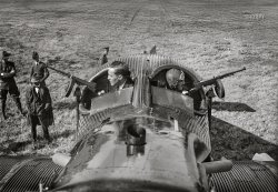 Washington, D.C. -- October 22, 1921. "Junkers-Larsen 'JL-12,' the dreadnaught of the air, arrived at Bolling Field yesterday after a 2½-hour flight from Long Island, New York. Designed principally for attack on enemy troops, it is equipped with 30 Thompson submachine guns and can discharge 3,000 bullets in four seconds. George Wise, machine gun expert, and Brooke Hyde-Pearson [1894-1924], pilot of the JL-12, preparing to demonstrate two of the machine guns." (Washington Post) 4x5 inch glass negative, Harris & Ewing Collection. View full size.